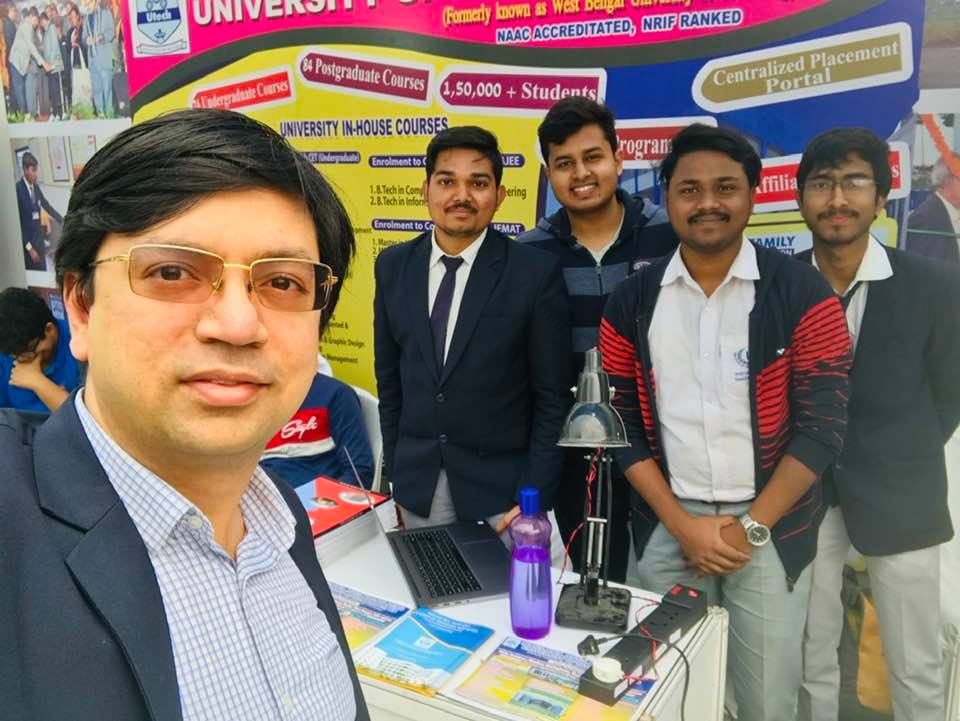 IEM students at WBUT International Bengali conference, showcasing their SMART home solution with an app controlled power strip